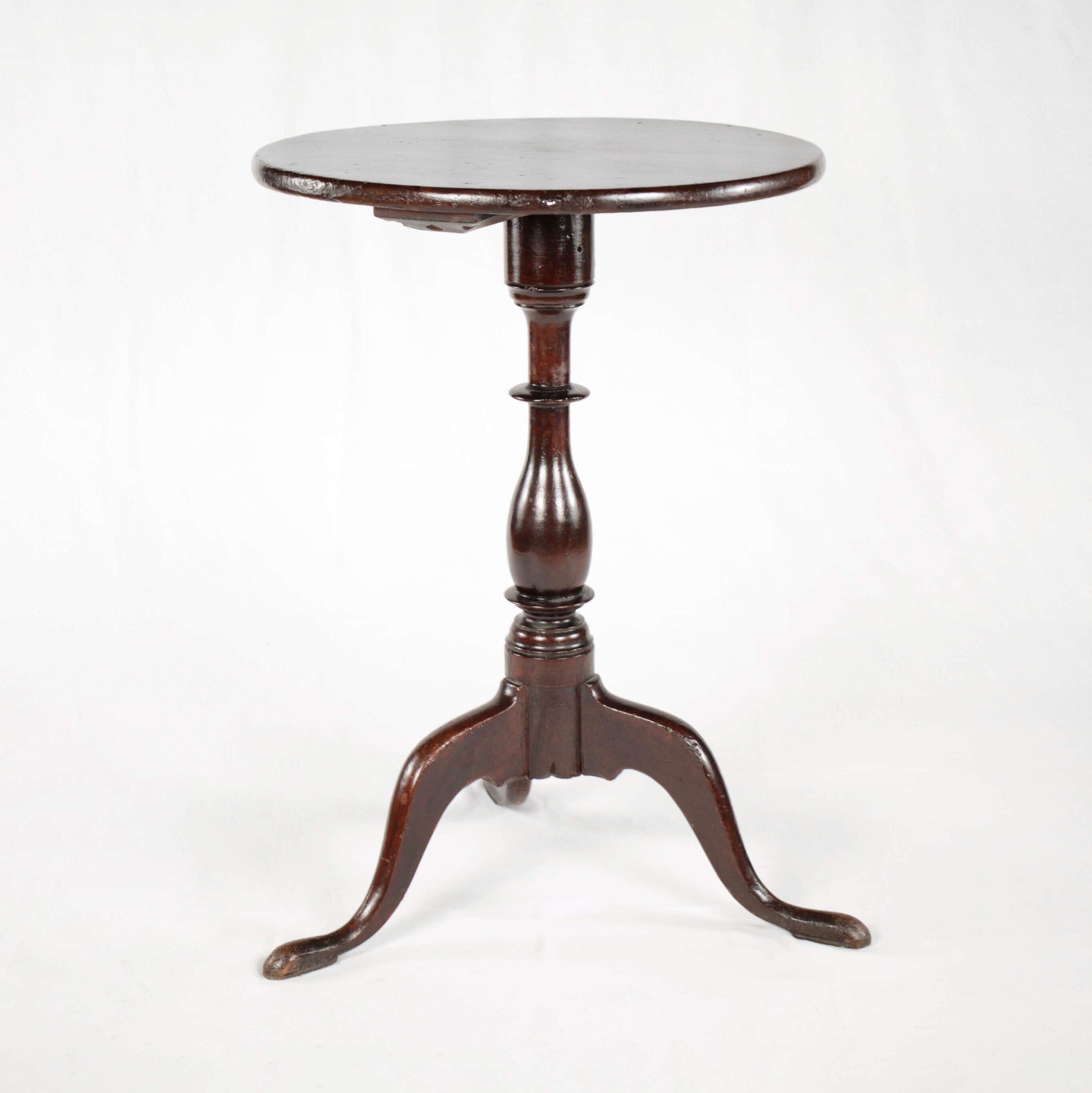 small table with round top and three legs
