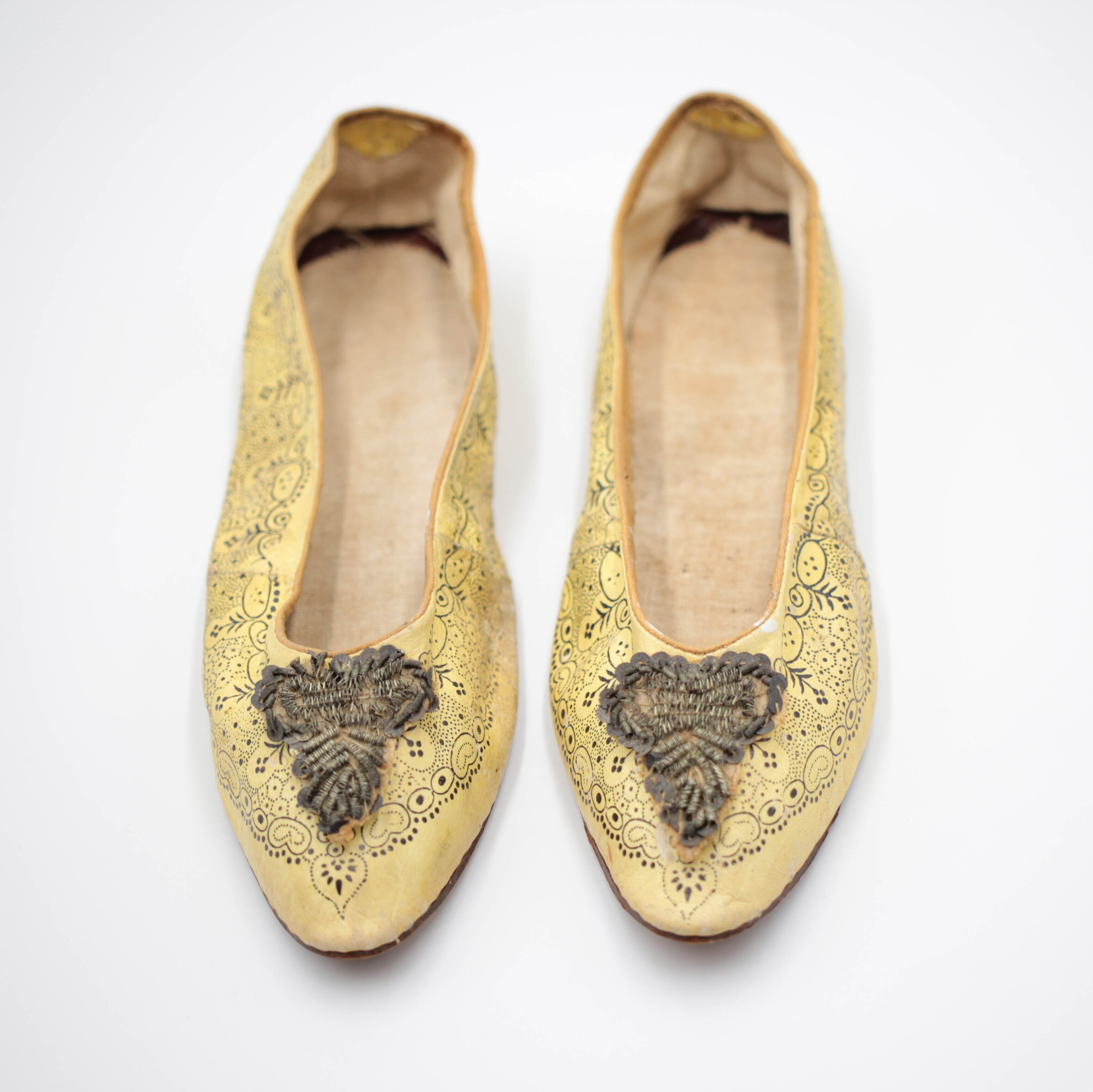 pair of yellow ladies shoes with beading