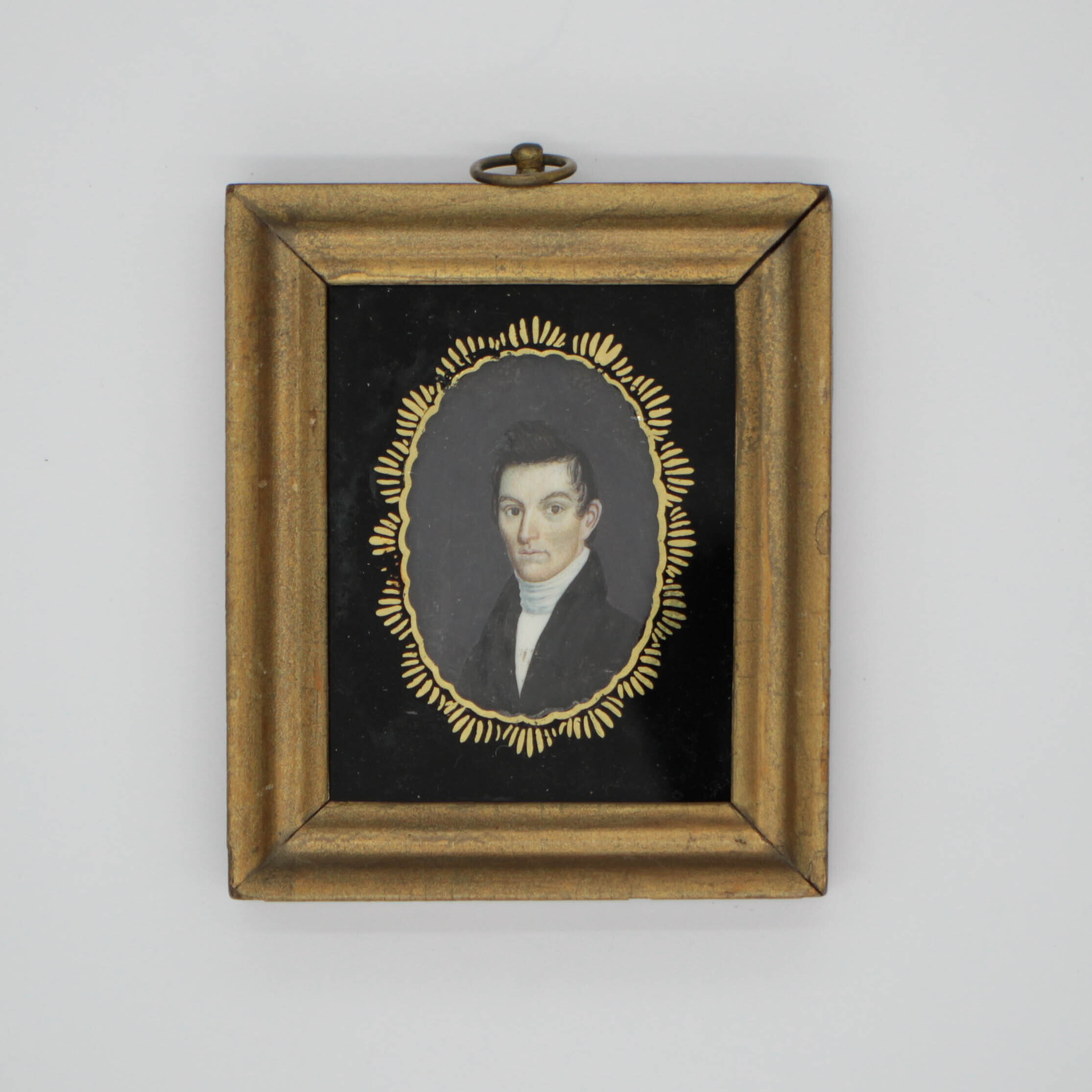 miniature portrait of man in gold frame