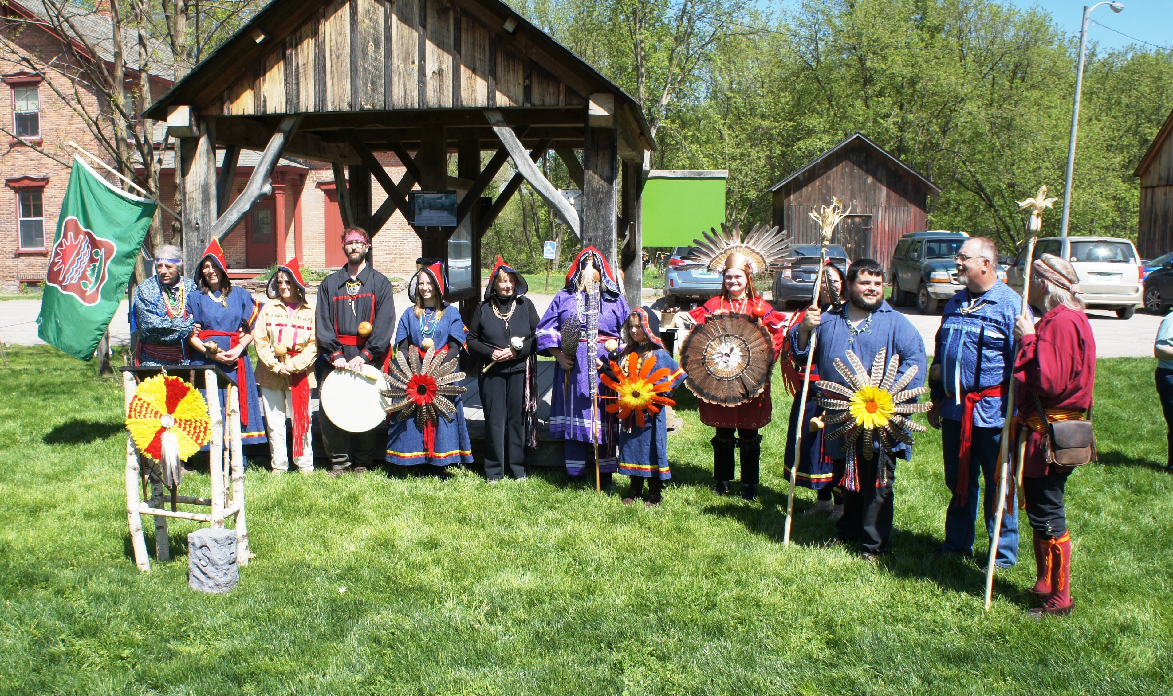 Abenaki in ceremonial garb standing in semi circle
