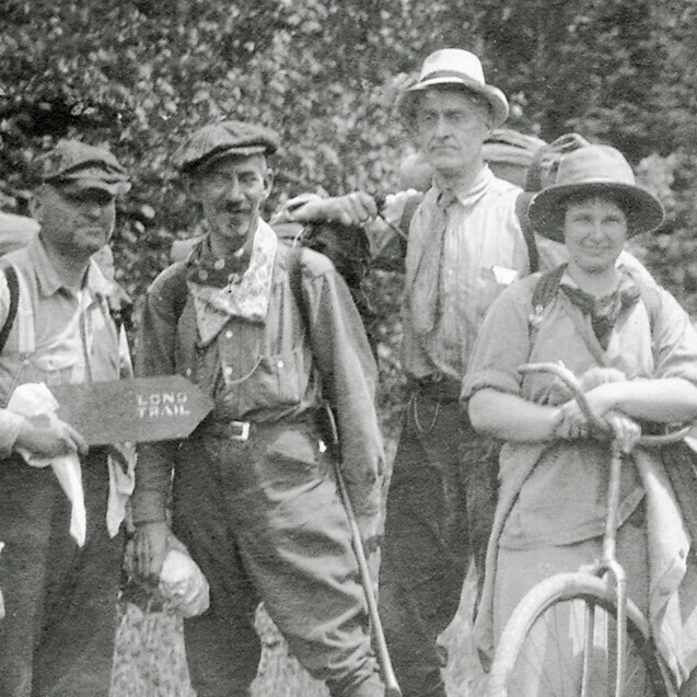old photo of four people going hiking