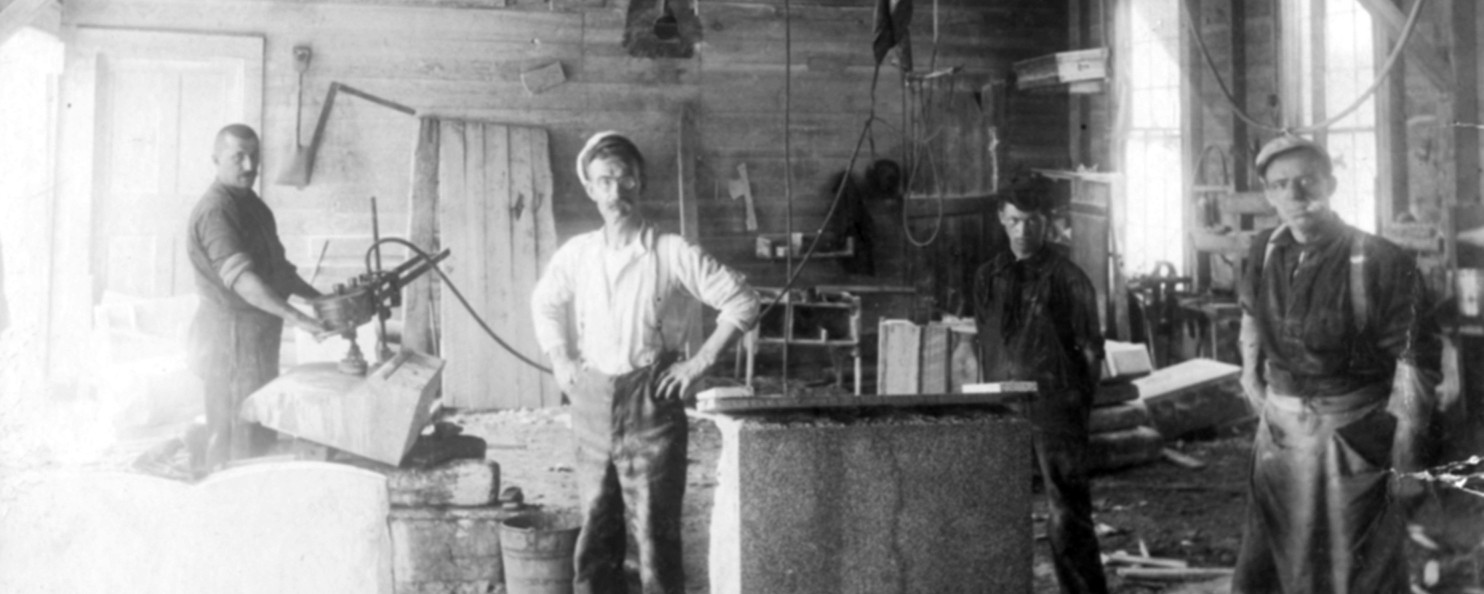 three men working in granite shed