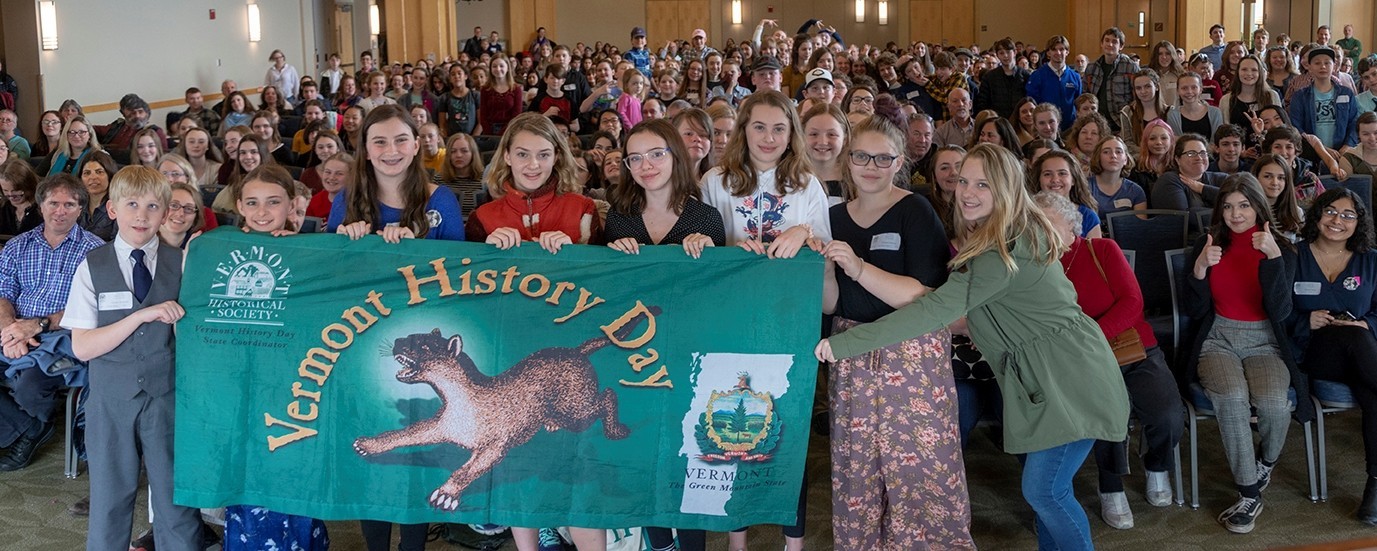 large group of students with Vermont History Day banner