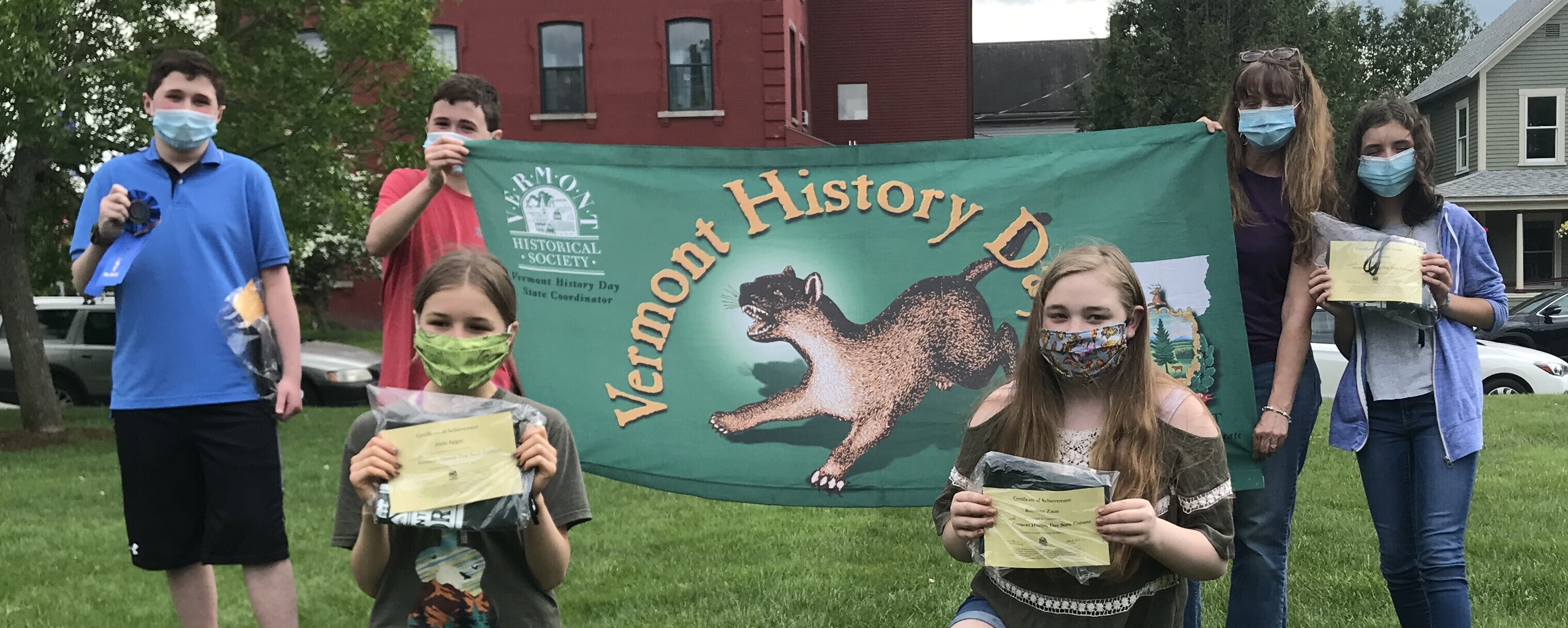 students from Lyndon Town School wearing masks with Vermont History Day banner