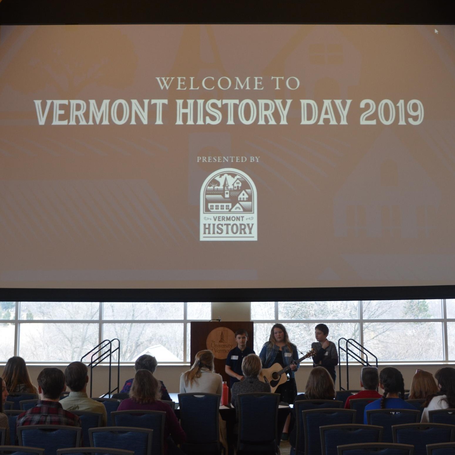 students performing under sign that says Welcome to Vermont History Day 2019