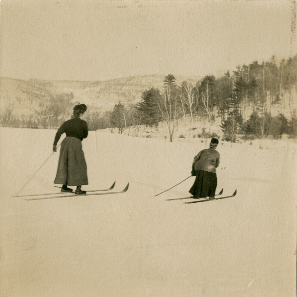 old photo of two women skiing with one pole