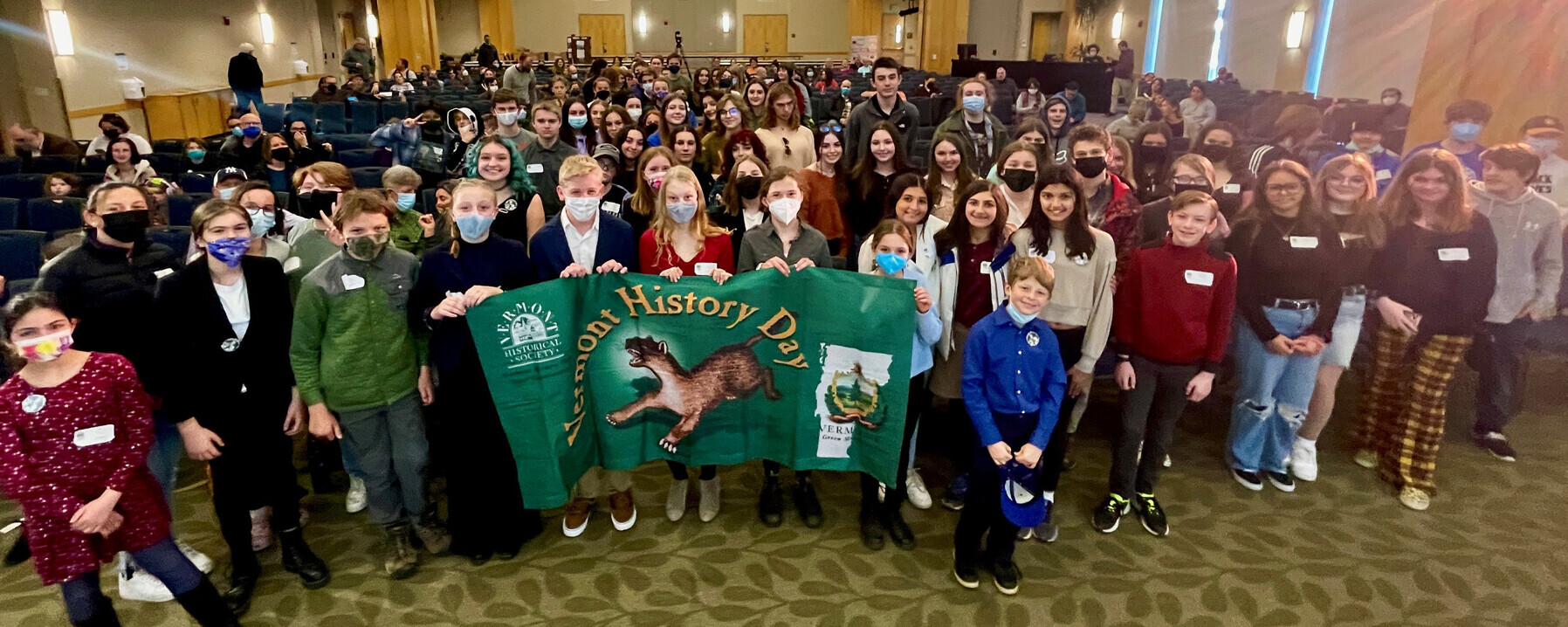 Large group of students with Vermont History Day banner.